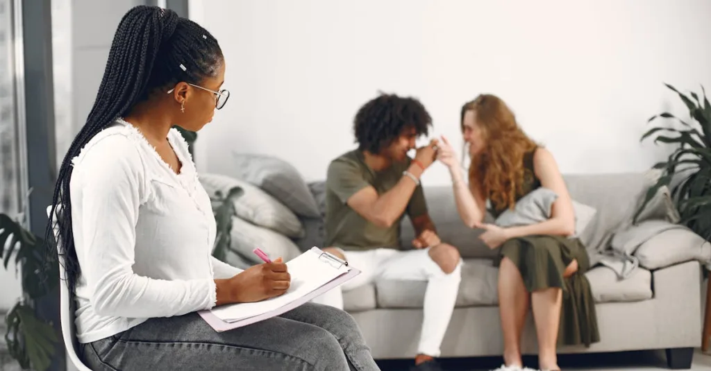 Therapist with clipboard taking notes while a couple on a sofa talk together about betrayal in a bright living room.